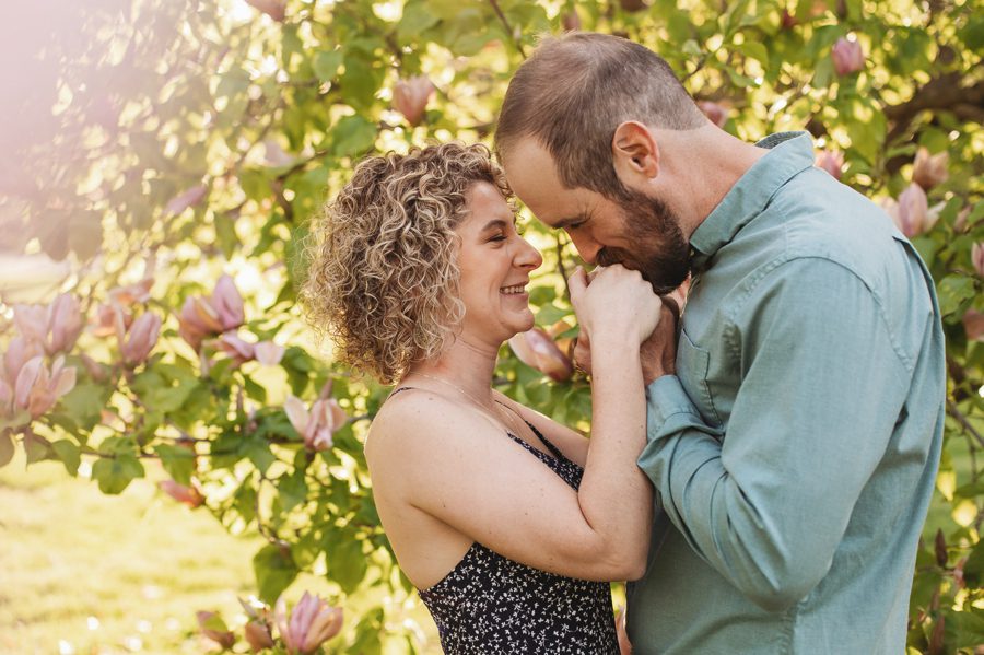 man kissing fiancés hand at Columbus Ohio park