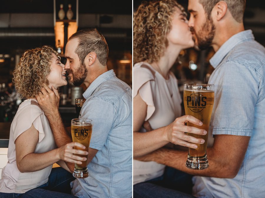 engaged couple kissing at bar at Pins Mechanical Engagement