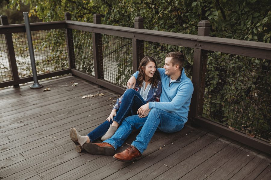 man in light blue sweater with arm around fiancé