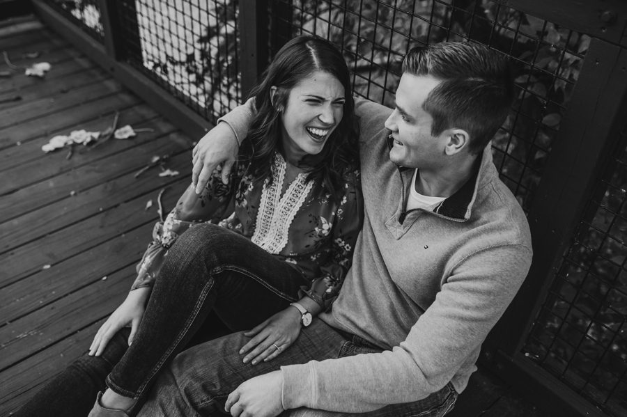 black and white image of woman laughing with fiancés arm around her at Scioto Audubon Metro Park engagement