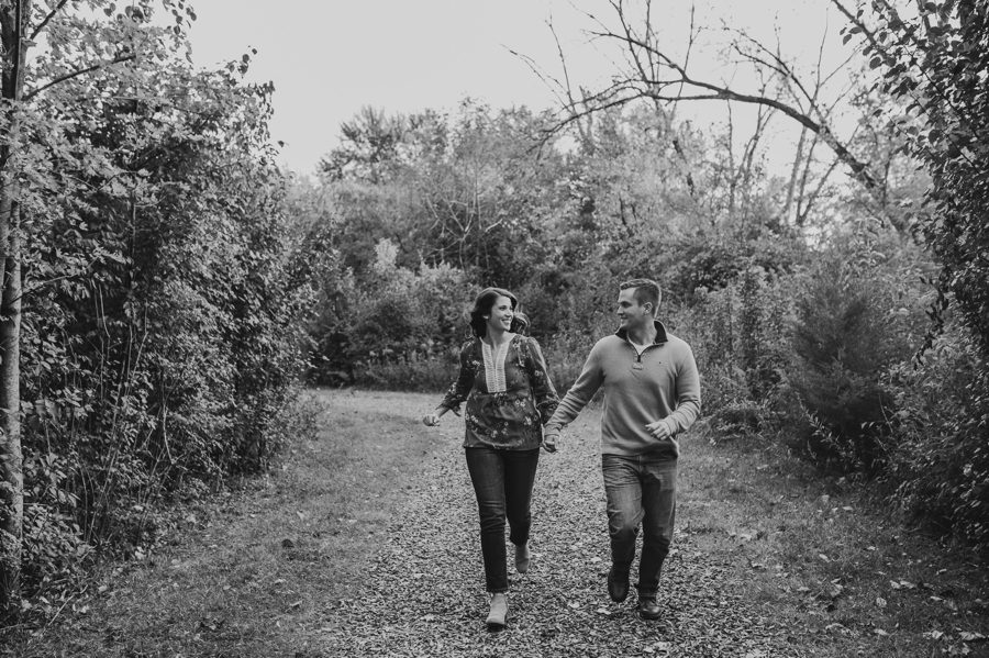 black and white image of couple running on a walking path