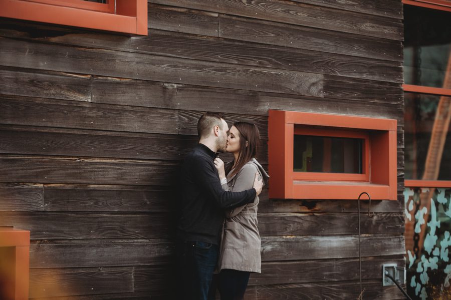 Scioto Audubon Photos of engaged couple kissing alongside building of Grange Insurance Audubon Center