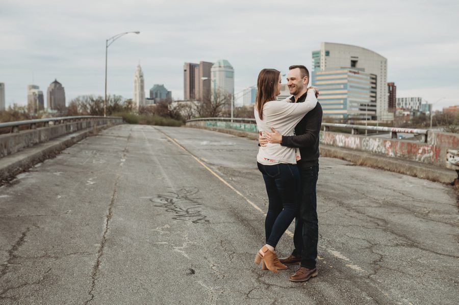 engaged couple on abandoned freeway dancing together