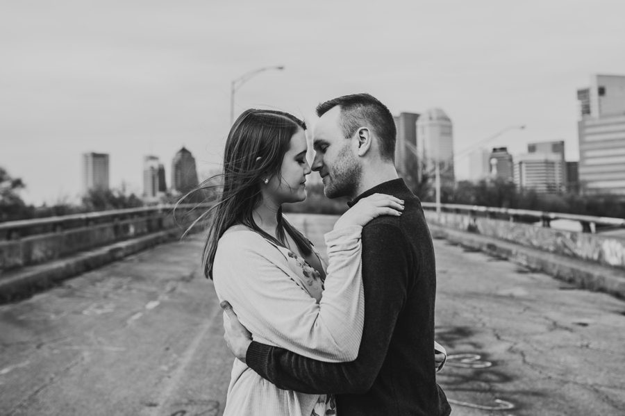 black and white image of engaged couple being romantic