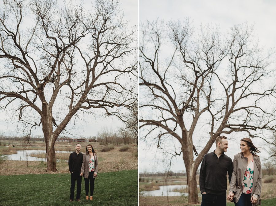 man and woman looking at each other with big oak tree