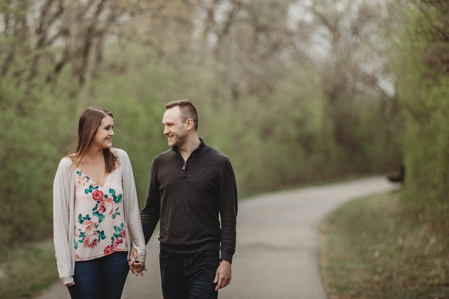 engaged couple holding hands and walking on path at Scioto Audubon Photos
