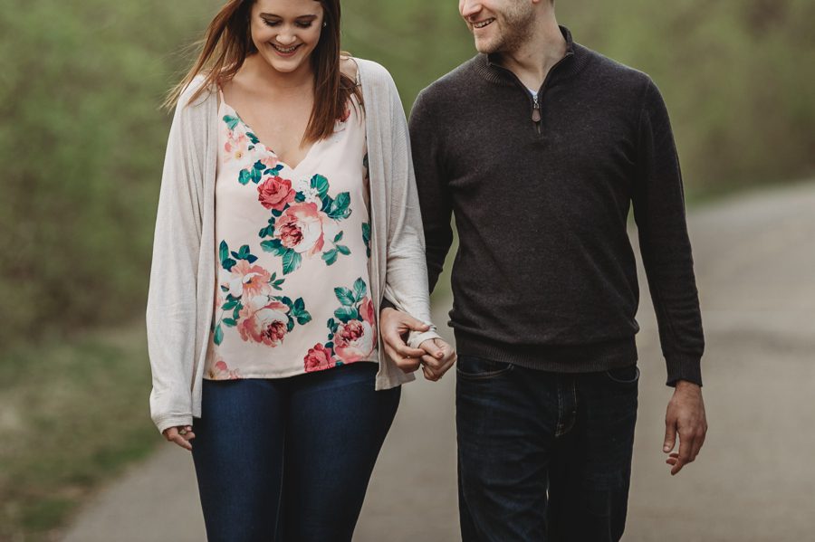 close up image of engaged couple holding hands
