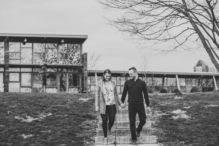 black and white image of couple walking down flight of steps at outdoor park