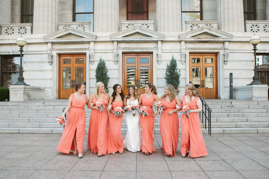 bride and bridesmaids walking with arms linked at The Ivory Room