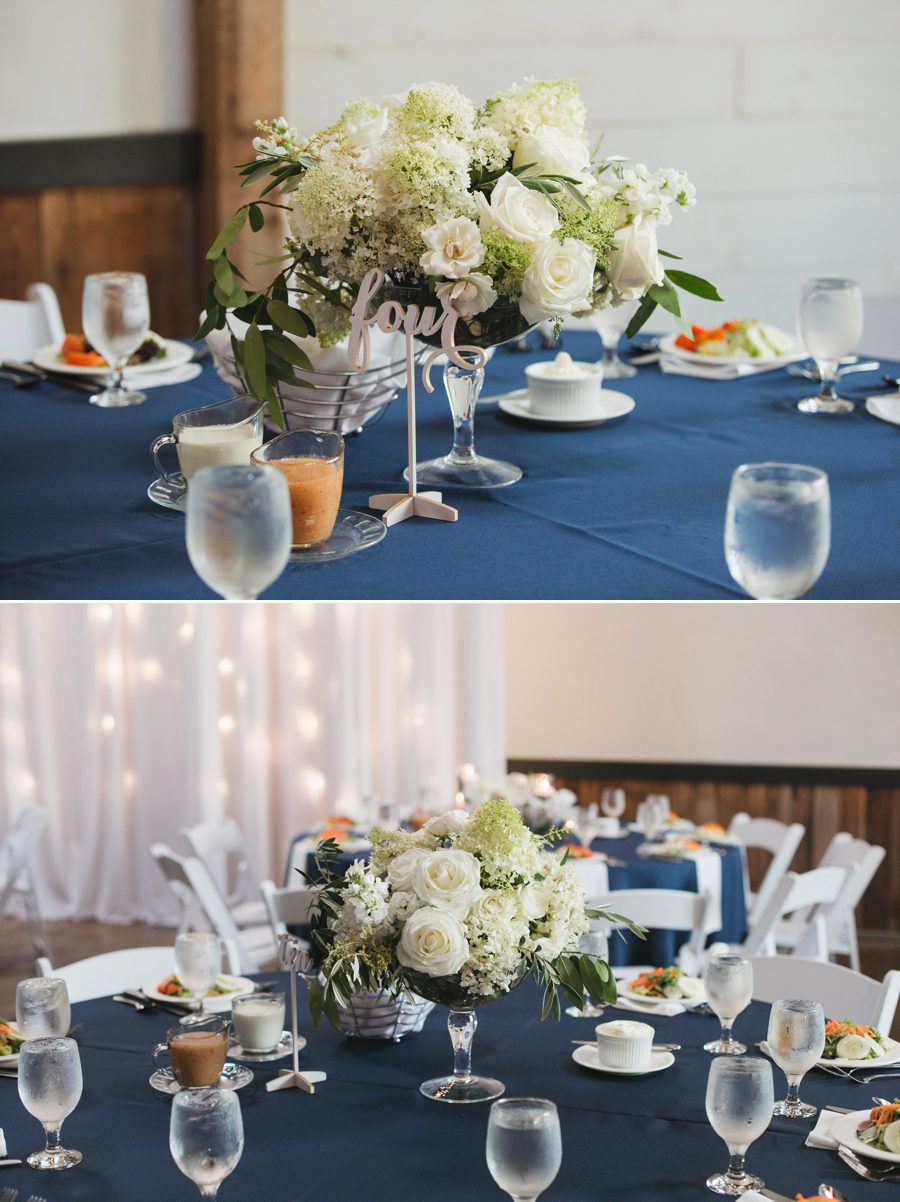 navy blue table linens with neutral floral arrangements