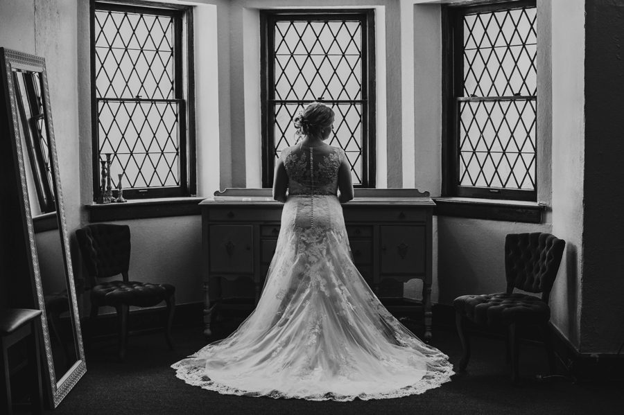 black and white photo of bride in front of window at Tiffany Blue Wedding in Columbus Ohio The Bluestone