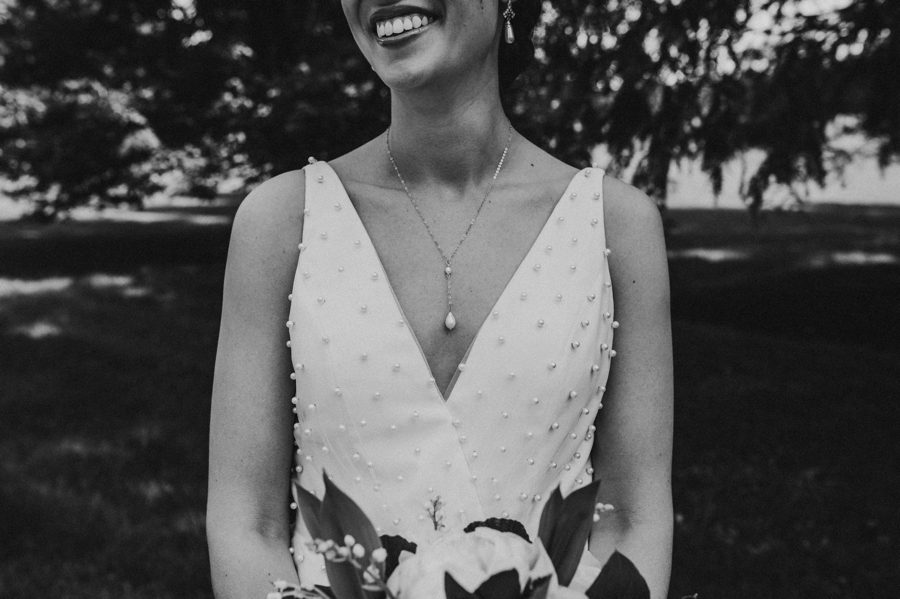 Black and white capture of Kelsey's drop down pearl necklace and pearl wedding dress