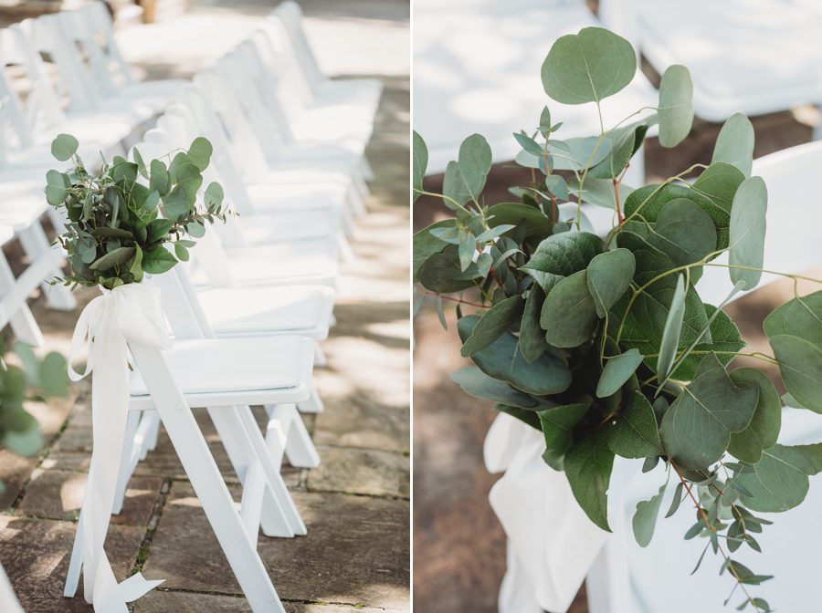 White ceremony folding chairs with eucalyptus and white bows