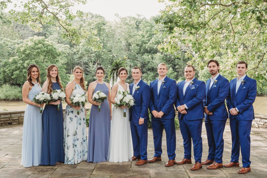 Kelsey and Jon posing with their wedding party in shades of blue hues at Columbus, Ohio Darby House