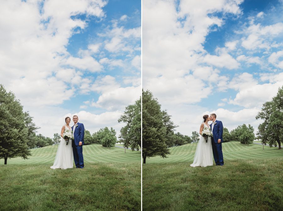 Kelsey and Jon kissing in front of large hill with beautiful blue skies at their Darby House wedding