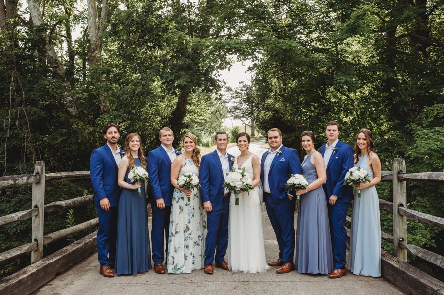 Kelsey and Jon with their wedding party wearing mixed shades of blue at Columbus, Ohio Darby House