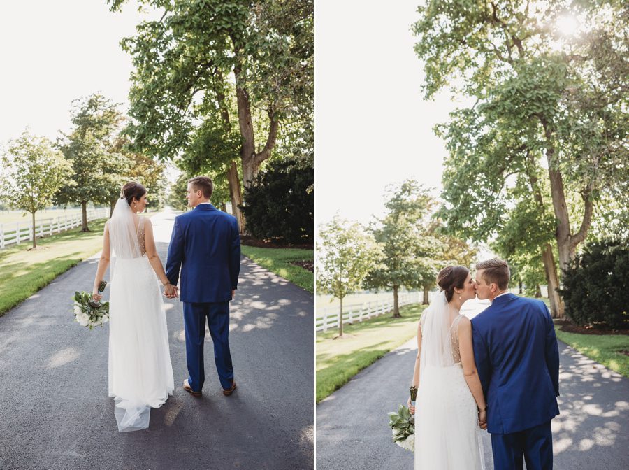 Kelsey and Jon kissing along the driveway at The Darby House with white picket fence