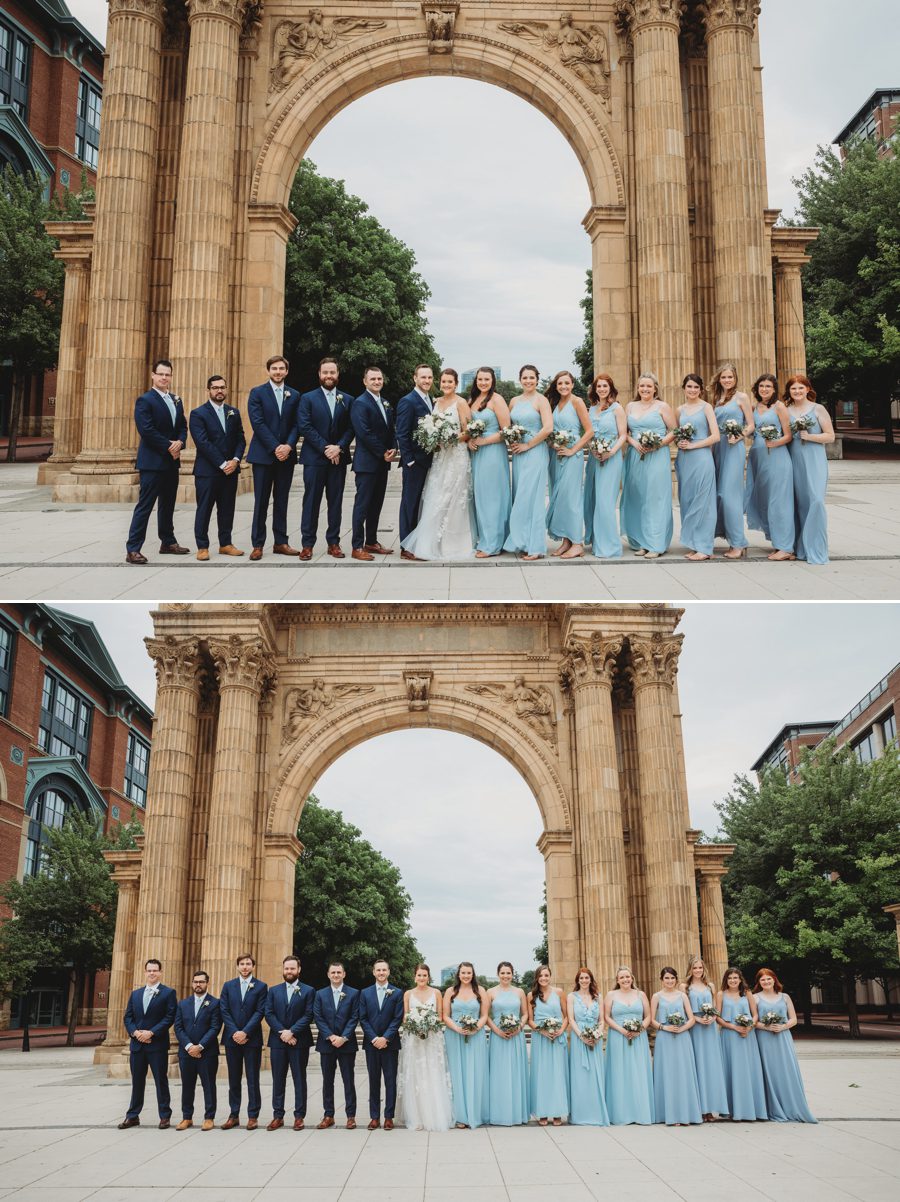 Wedding party wearing powder blue and navy blue in front of the arch at McFerson Commons Park in Columbus, Ohio