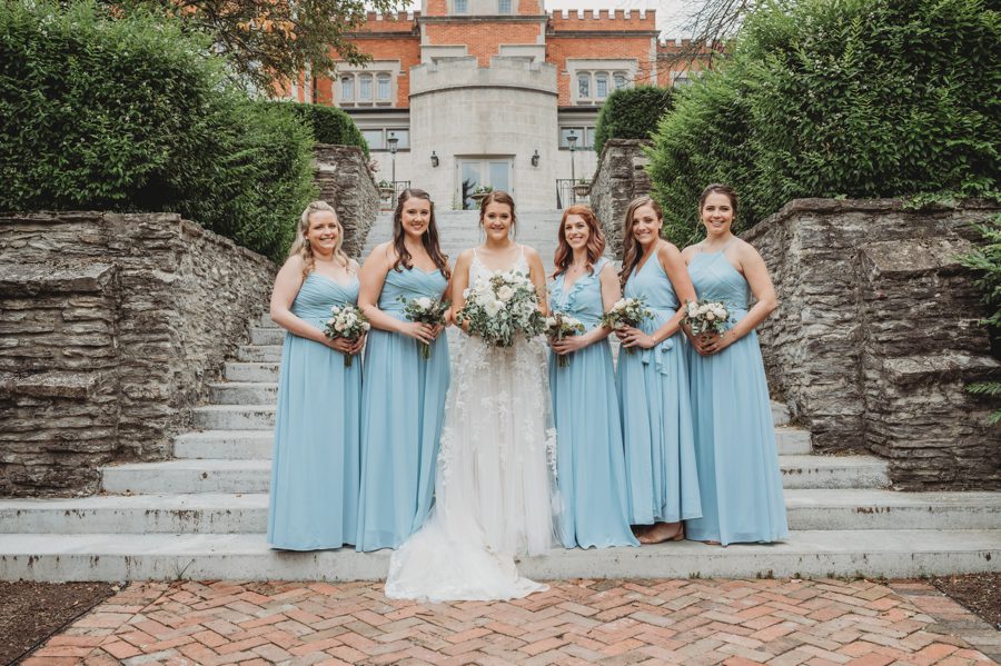 Bride Emilee with bridesmaids wearing powder blue dresses at High Line Car House