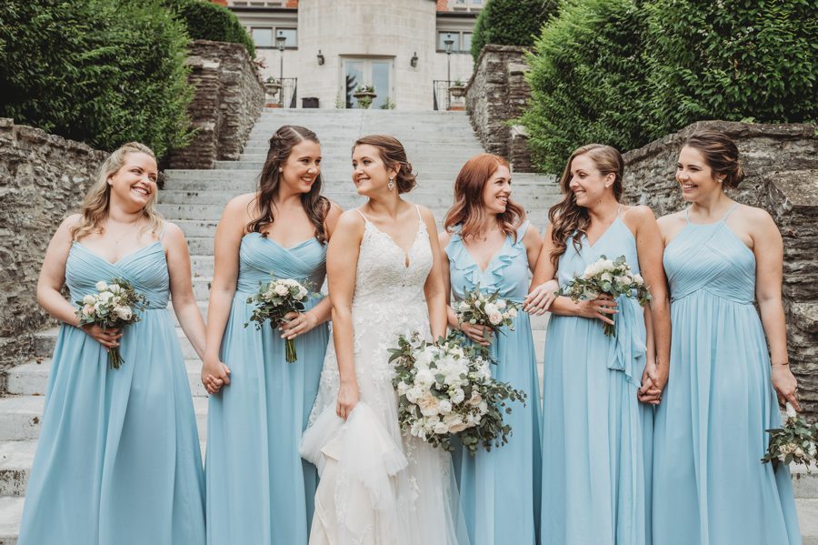 Powder blue bridesmaids dresses with neutral bouquets