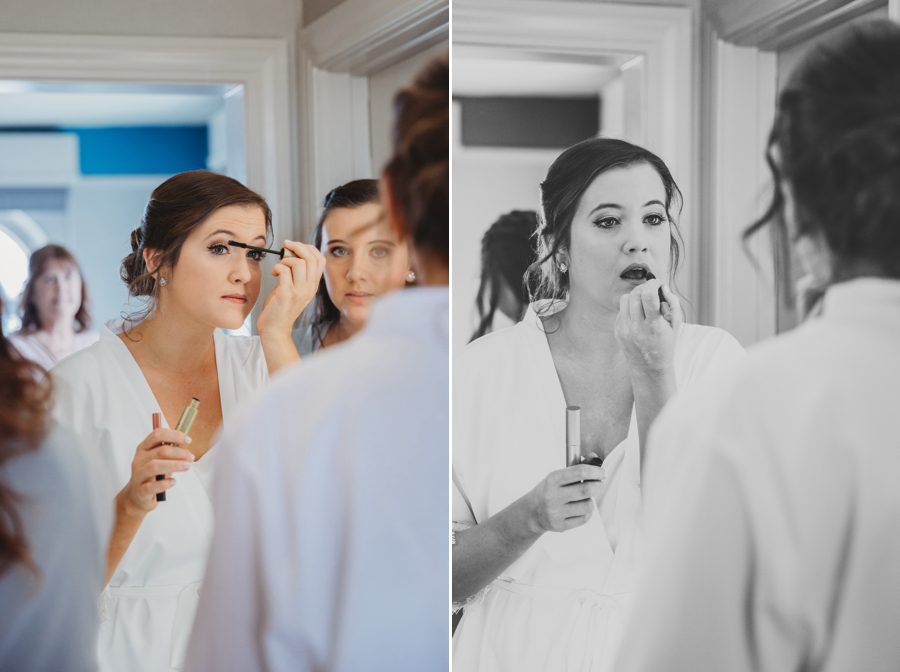 Bride Emilee touching up makeup before getting into gown