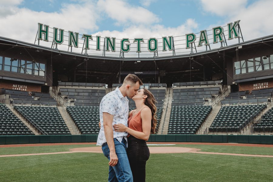 engaged couple kissing on baseball mound at Huntington Park Engagement Photos