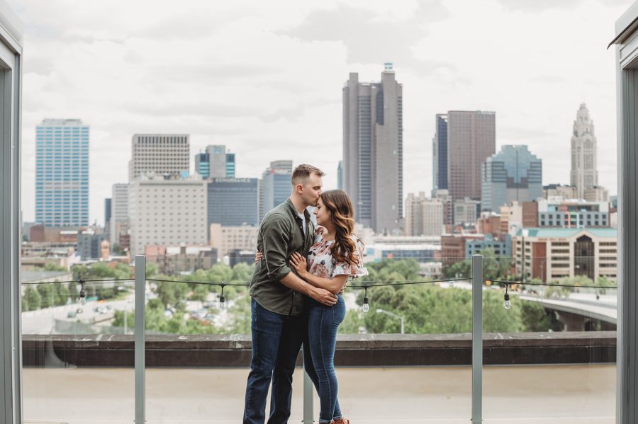 man kissing fiancé on forehead at Huntington Park Engagement Photos
