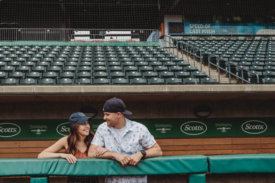 engaged couple looking at each other in stadium at Huntington Park Engagement Photos