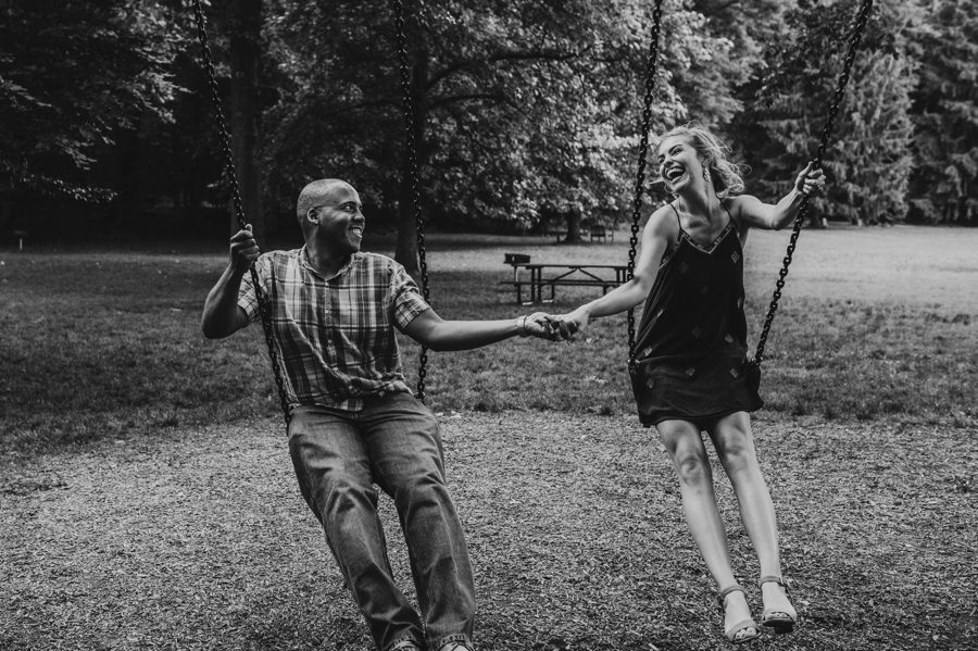 Jeffrey Mansion Engagement Photos with Rachel and Sean swinging on swings in black and white