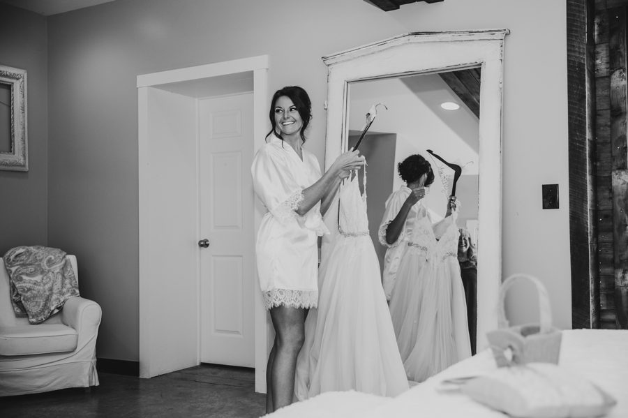 Candid capture of Cortni getting into her wedding gown