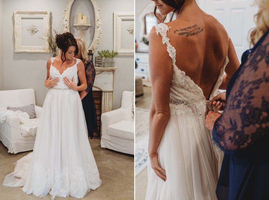 Mother of bride helping Cortni get into her wedding gown