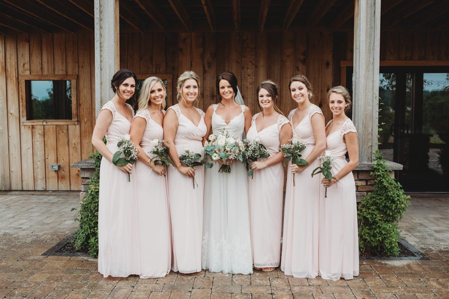 Cortni and her bridesmaids wearing pale pink dresses with lace cap sleeves