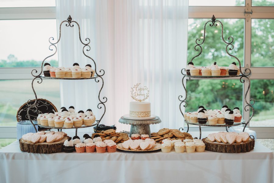 Dessert table with cupcake towers and heart shaped sugar cookies