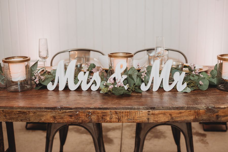 Mrs and Mr white signs on wood head table