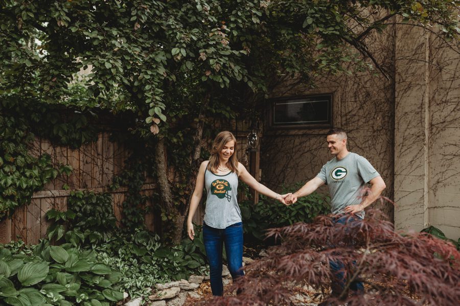 engaged couple in private backyard walking together